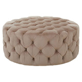 Beige velvet round ottoman stool with tufted detailing, featuring a soft, plush surface and a circular shape, suitable for use as a footrest or additional seating