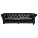 Antique black leather Chesterfield sofa featuring a classic tufted design, three spacious seats, and rolled arms, supported by elegant wooden legs