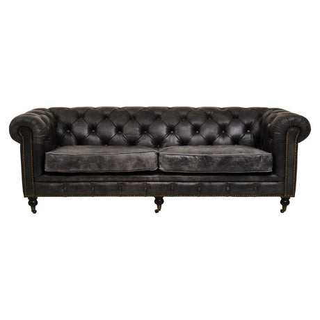 Antique black leather Chesterfield sofa featuring a classic tufted design, three spacious seats, and rolled arms, supported by elegant wooden legs