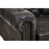 Antique black leather upholstery with a tufted design and rolled armrest, featuring decorative stitching along the seams. The sofa showcases a classic Chesterfield style with a luxurious and worn appearance, highlighting its vintage charm