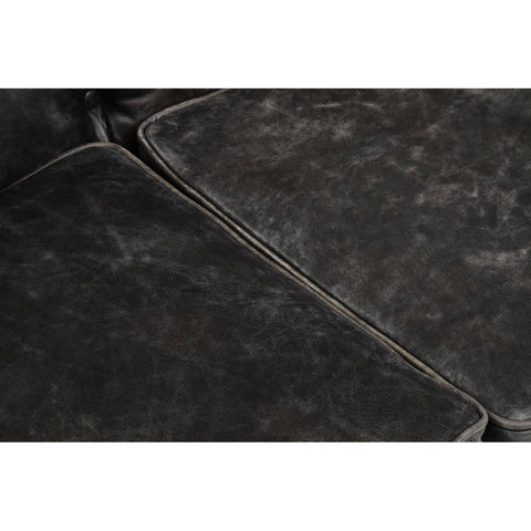 Close-up view of the Hoxton Antique Black 3 Seat Chesterfield Leather Sofa, showcasing the rich, textured black leather upholstery with visible stitching and a slightly distressed finish, highlighting its vintage appeal