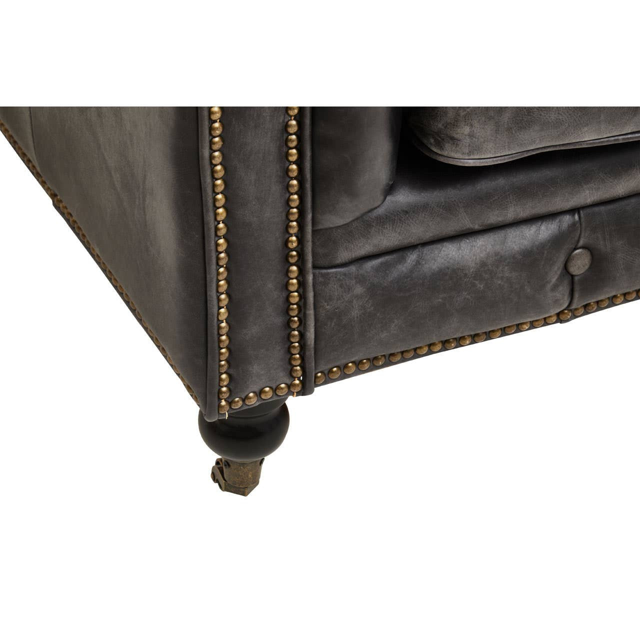 Close-up view of the corner of the Hoxton Antique Black 3 Seat Chesterfield Leather Sofa, showcasing the rich black leather upholstery, detailed stitching, and a wooden leg with a brass caster