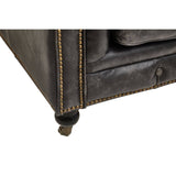 Close-up view of the corner of the Hoxton Antique Black 3 Seat Chesterfield Leather Sofa, showcasing the rich black leather upholstery, detailed stitching, and a wooden leg with a brass caster