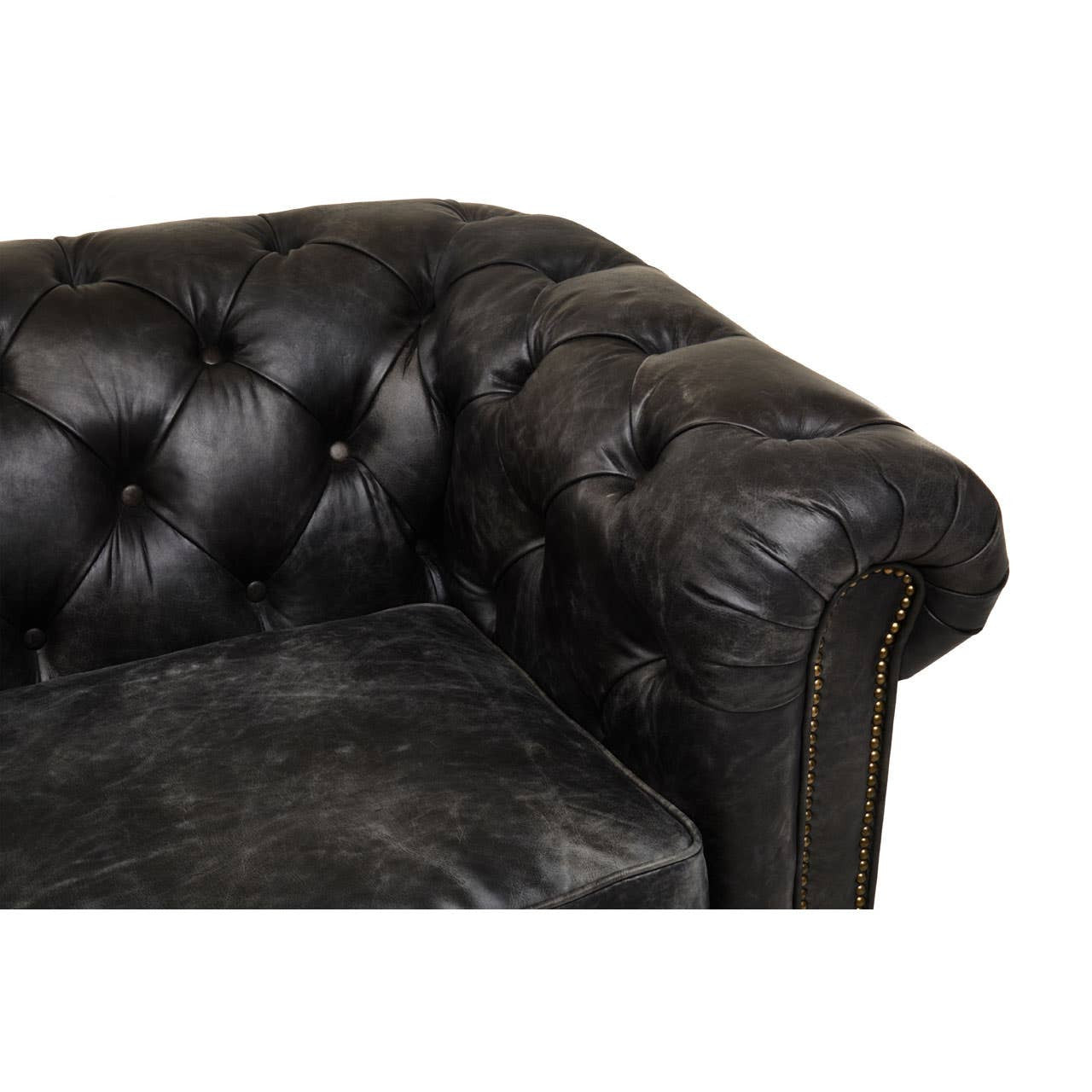 Antique black leather Chesterfield sofa featuring a tufted design on the armrest and back, showcasing a classic and elegant style. The leather has a distressed finish, adding character to the piece