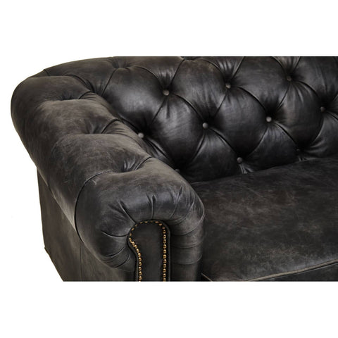 Close-up view of the armrest and tufted back of a Hoxton Antique Black 3 Seat Chesterfield Leather Sofa, showcasing the rich, textured black leather and decorative buttons. The sofa features a classic design with a curved arm and visible stitching details