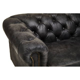 Close-up view of the armrest and tufted back of a Hoxton Antique Black 3 Seat Chesterfield Leather Sofa, showcasing the rich, textured black leather and decorative buttons. The sofa features a classic design with a curved arm and visible stitching details