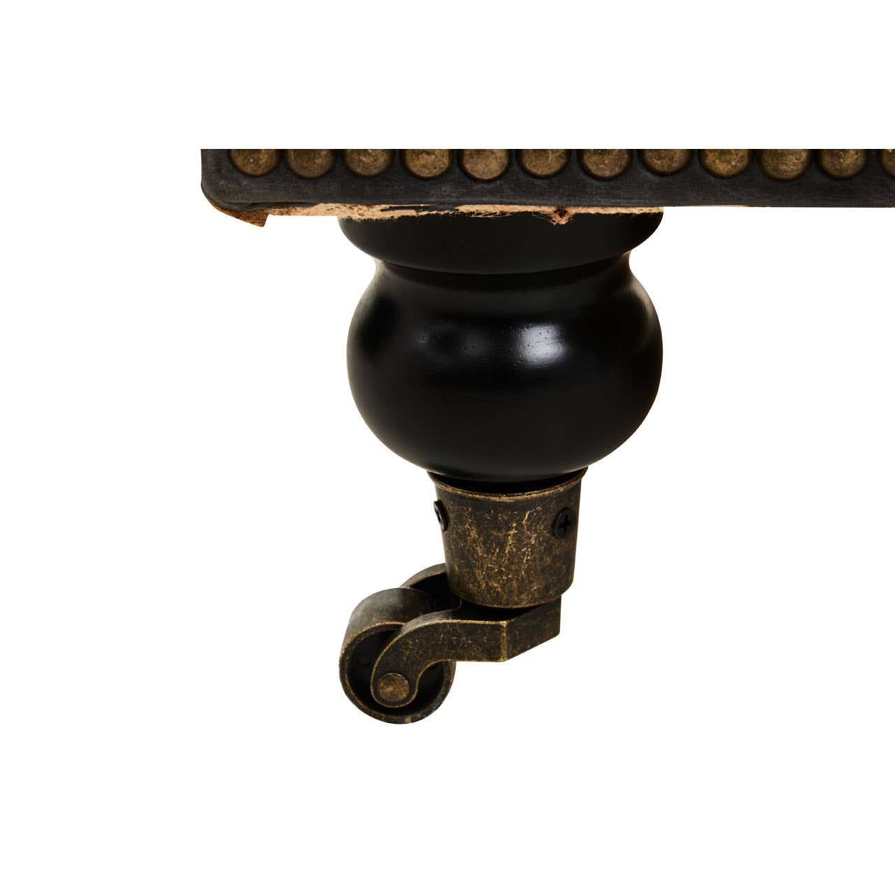 Close-up view of the ornate wooden leg of the Hoxton Antique Black 3 Seat Chesterfield Leather Sofa, featuring a round black wheel and intricate detailing along the edge. The leg is finished in a dark wood tone, complementing the overall antique aesthetic of the sofa