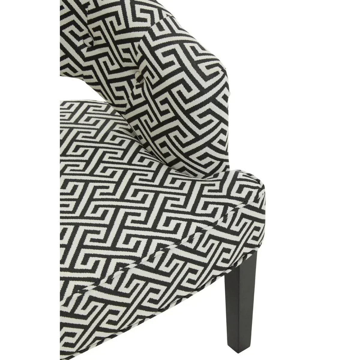 Black and white geometric fabric armchair with dark wooden leg, close-up of upholstery