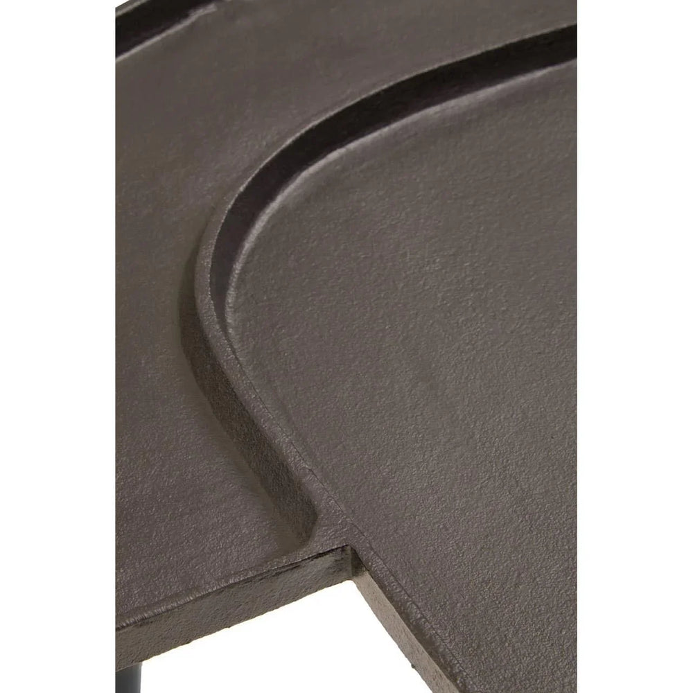 Close up of dark metal table top with curved edge and textured finish