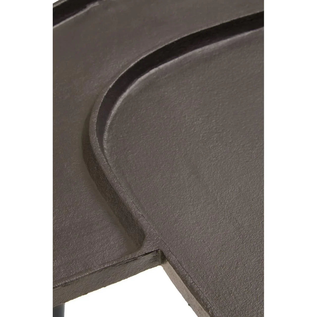 Close up of dark metal table top with curved edge and textured finish
