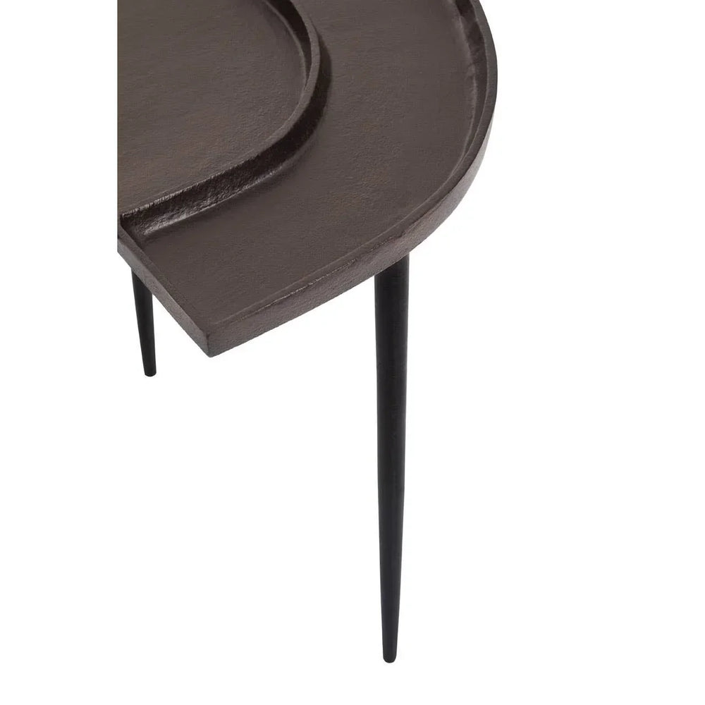 Dark brown metal side table with rounded edge and slim black legs, close-up view
