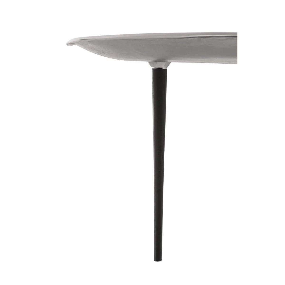 Closeup of round side table with white top and slim black metal leg