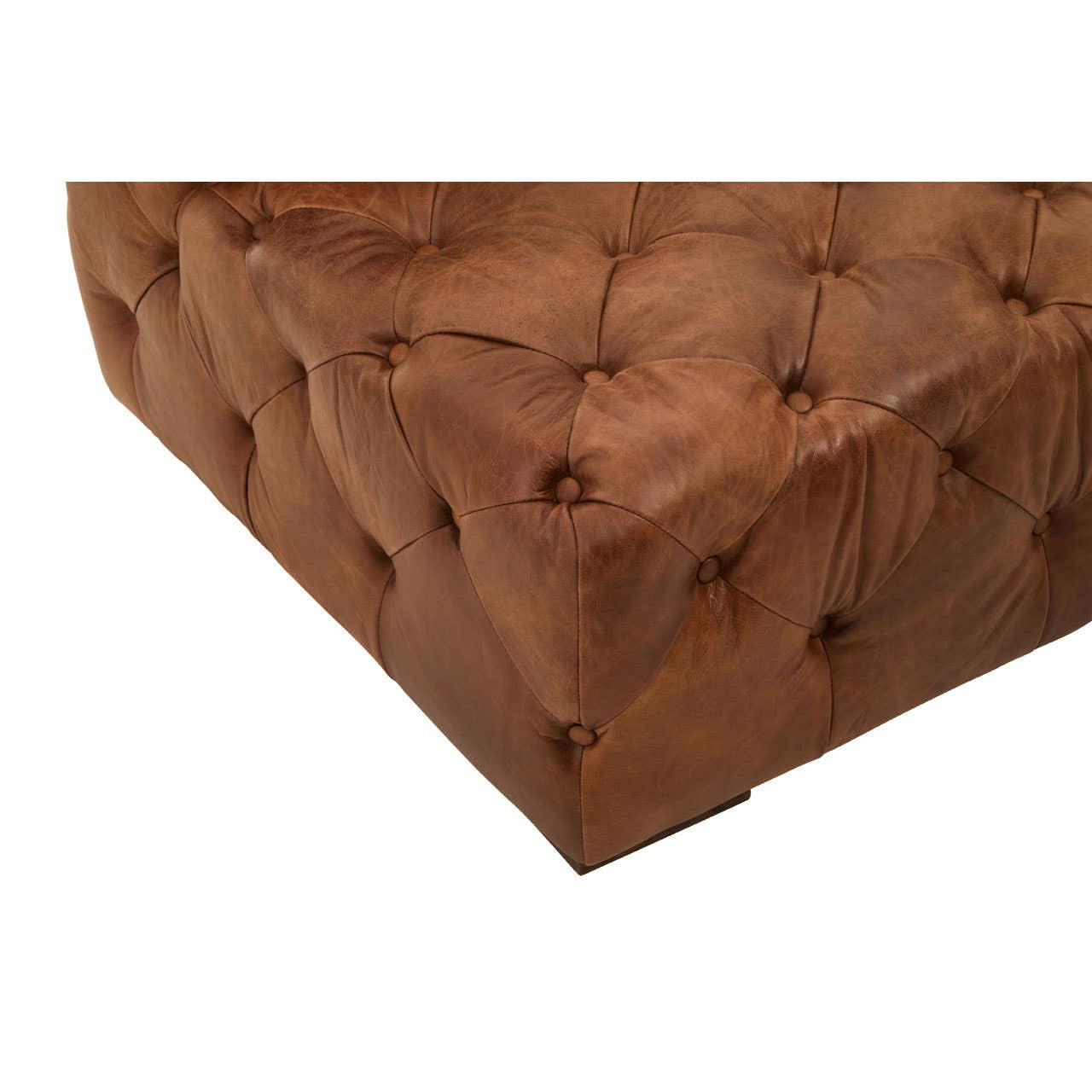 Brown leather corner of a modern Chesterfield modular sofa featuring tufted detailing and a right armrest. The rich texture of the leather is visible, showcasing a warm, inviting color
