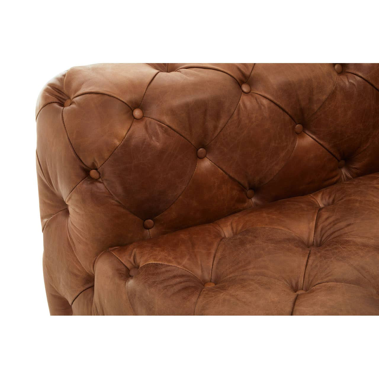 Brown leather upholstery with a tufted design, showcasing a corner of a modern Chesterfield modular sofa. The right armrest is visible, featuring rounded edges and decorative buttons that enhance its elegant appearance