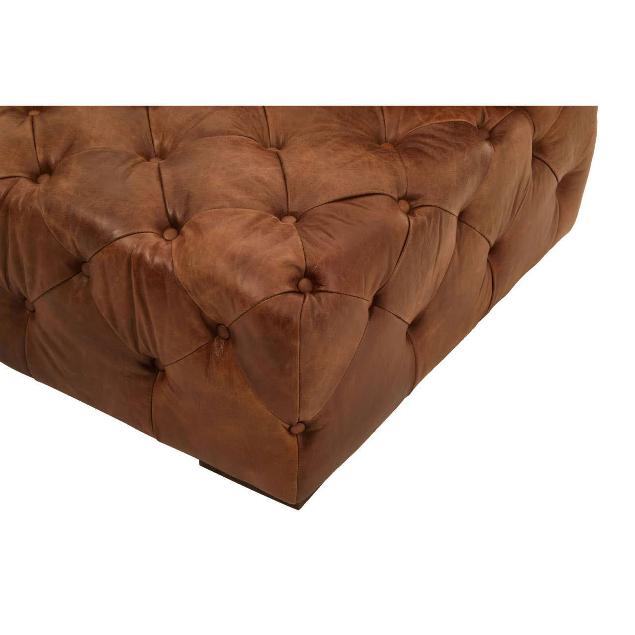 Close-up view of the tufted brown leather upholstery of a left arm modern Chesterfield sofa, showcasing the rich texture and button detailing on the surface