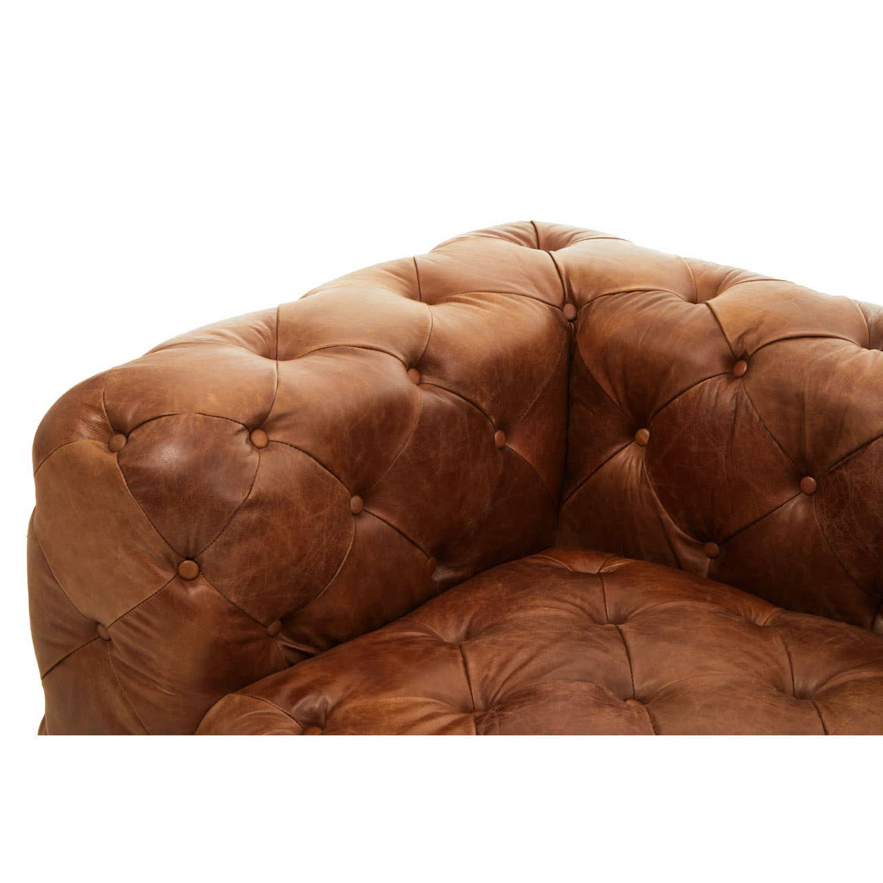 Brown leather upholstery with a tufted design, showcasing the left arm of a modern Chesterfield sofa. The corner features rounded edges and visible stitching, highlighting the sofa's elegant craftsmanship