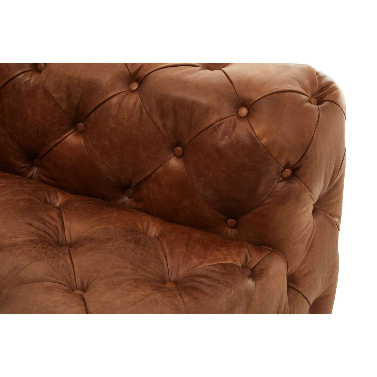 Brown leather upholstery with a tufted design, showcasing a close-up view of the left arm of a modern Chesterfield sofa. The surface is smooth with visible stitching and decorative buttons, highlighting the luxurious texture and craftsmanship