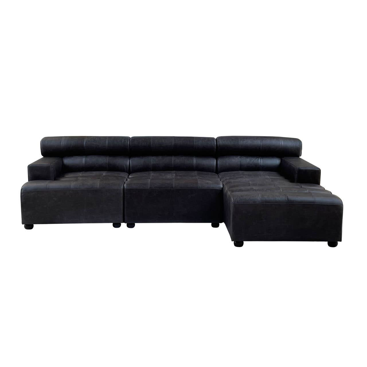 A modular chaise sofa in antique black leather featuring a right arm design. The sofa has a sleek, contemporary shape with plush cushions and a low backrest, providing a modern aesthetic suitable for various living spaces. The legs are short and sturdy, enhancing stability