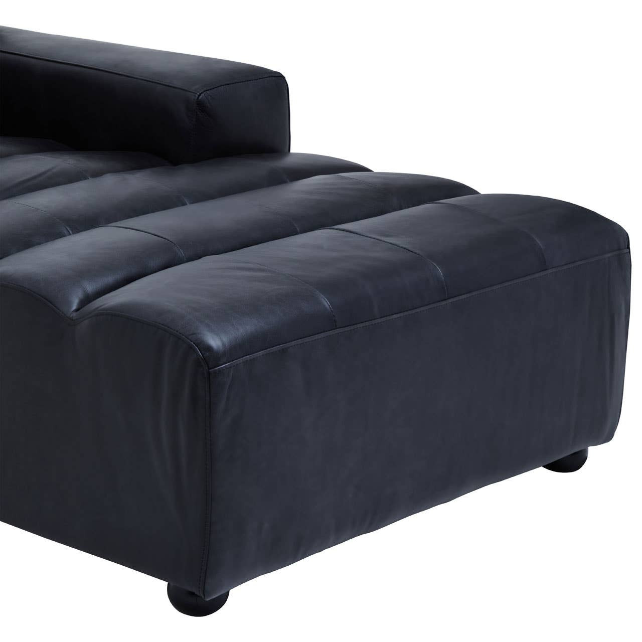 Antique black leather modular chaise sofa with a right arm, featuring a sleek design and plush seating surface, supported by round feet