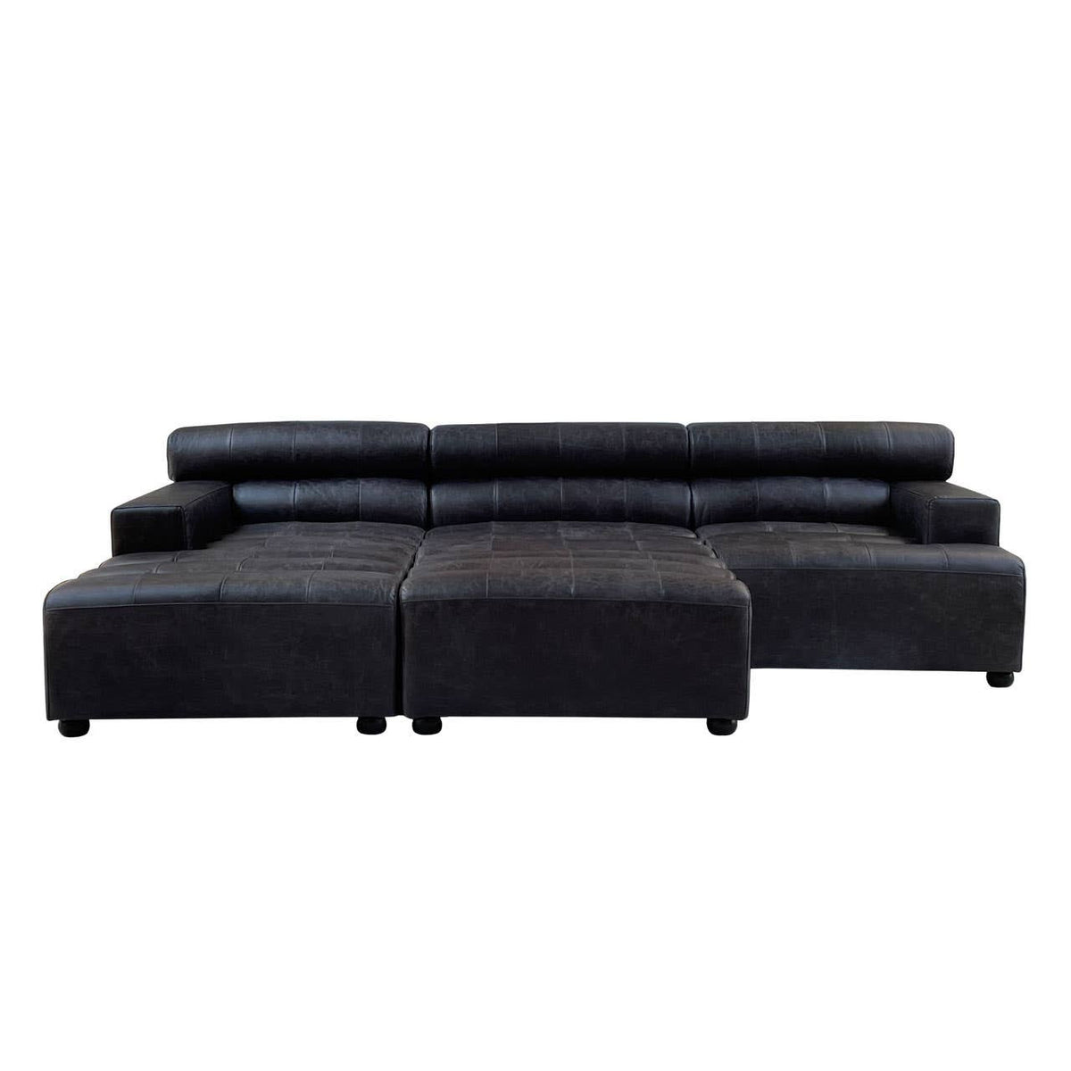 Black leather modular ottoman featuring a sleek, contemporary design with a low profile and rounded edges. The ottoman is divided into two sections, providing versatility in arrangement. The surface is smooth and polished, highlighting the rich texture of the leather