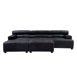 Black leather modular ottoman featuring a sleek, contemporary design with a low profile and rounded edges. The ottoman is divided into two sections, providing versatility in arrangement. The surface is smooth and polished, highlighting the rich texture of the leather