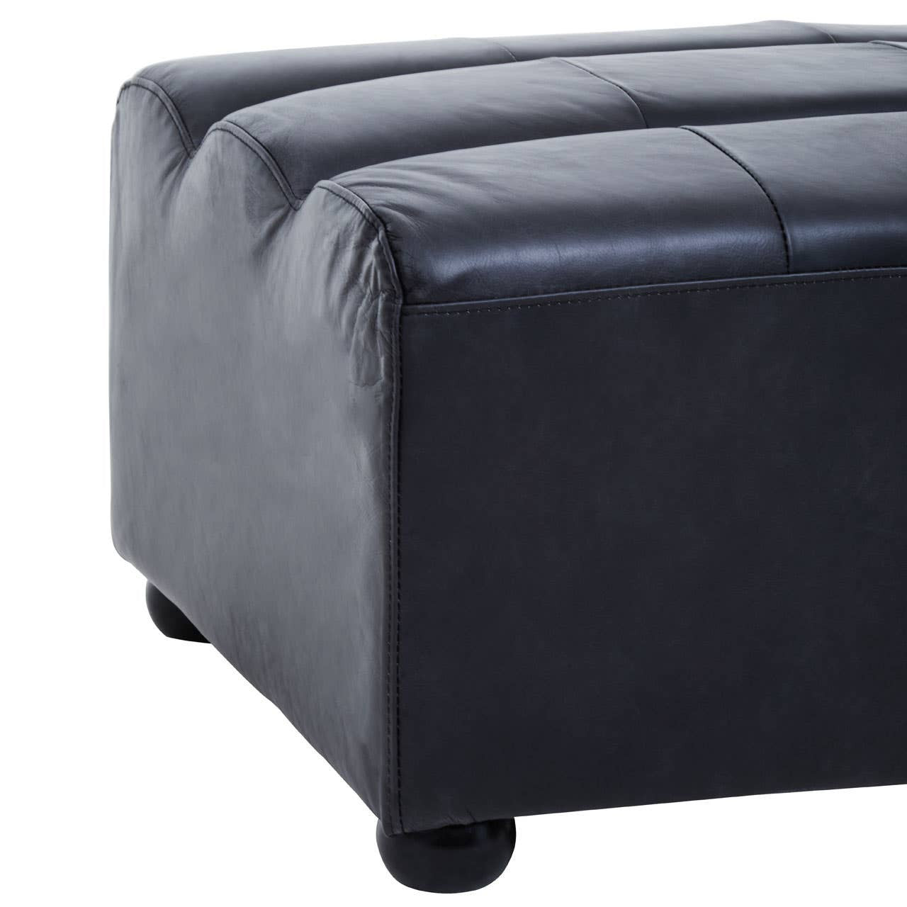 Antique black leather modular ottoman with a smooth, textured surface and rounded edges, featuring subtle stitching details and resting on small, rounded feet