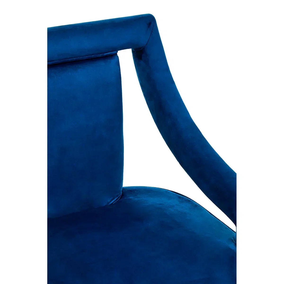 Close view of blue velvet dining chair backrest and curved armrest