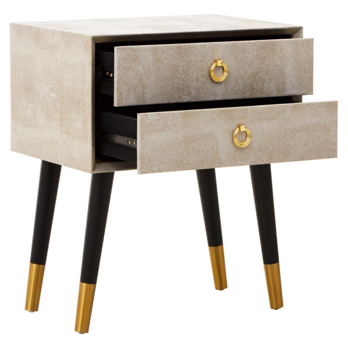 Beige bedside table with gold handles, two open drawers, and black legs with gold tips