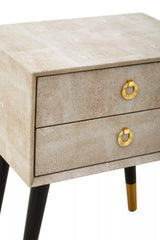 Beige two drawer bedside table with gold ring handles and tapered black and gold legs