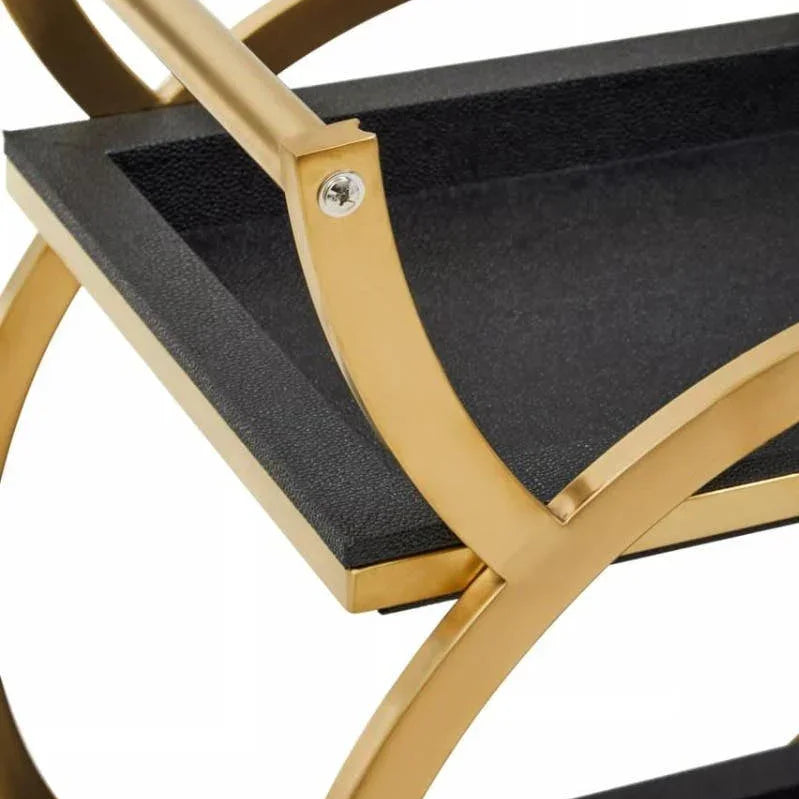 Close up of gold metal frame and black shelves on modern drinks trolley