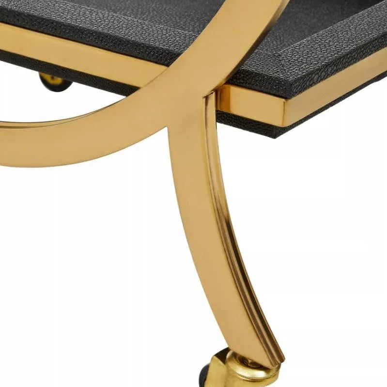 Gold metal bar cart leg with caster wheel and textured black shelf detail