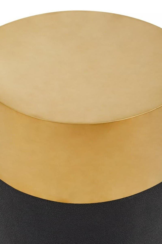 Round gold metal side table with black textured base, close-up top view