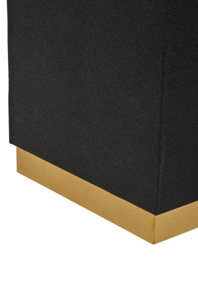 Black furniture base with textured finish and gold accent detail, close-up corner view