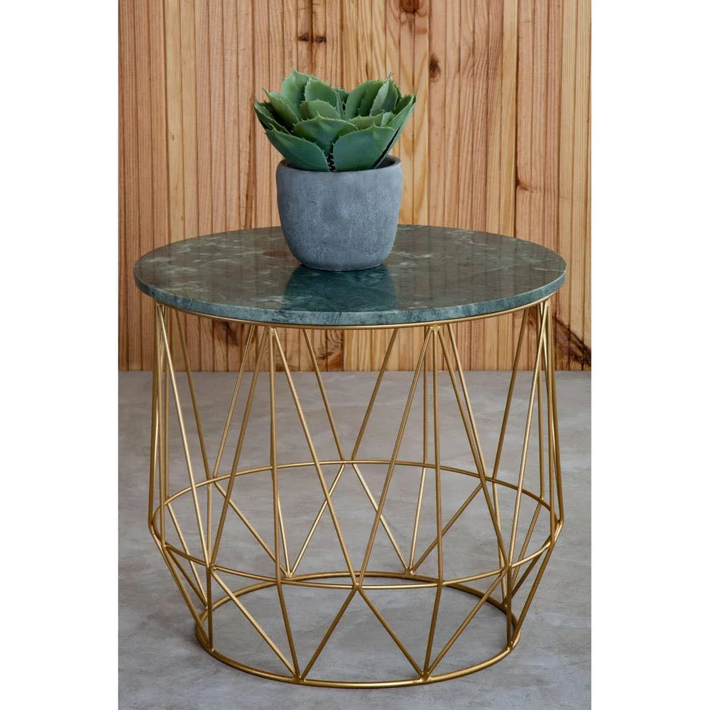 round marble top coffee table with gold metal geometric base and potted plant