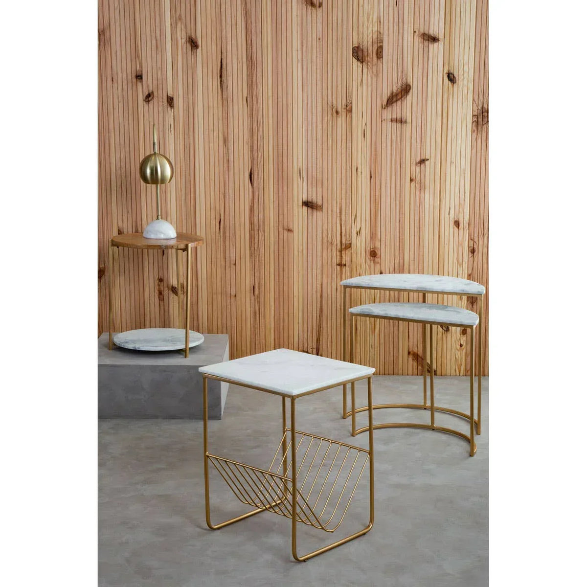 Modern marble top side tables with gold metal frames against wood panel wall