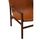 Close-up of tan leather armchair with dark wood frame and stitched seat detail