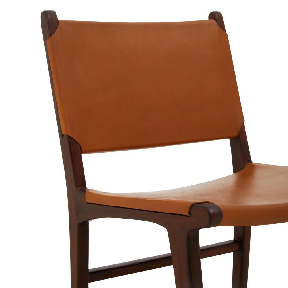 Brown leather dining chair with wooden frame, close-up of seat and backrest