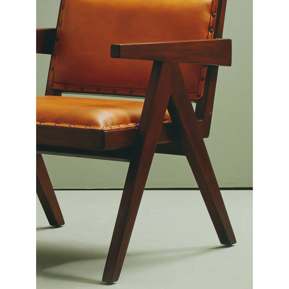 Leather accent chair with wooden frame and armrest, angled legs and stud detailing