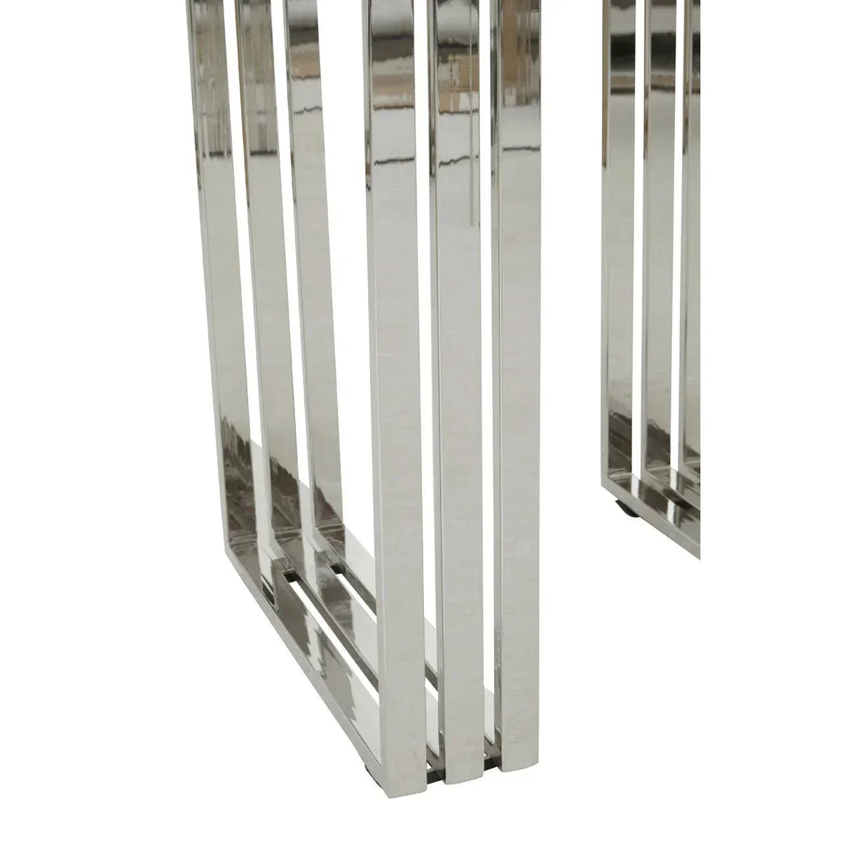 Closeup of chrome metal table legs with geometric open frame design