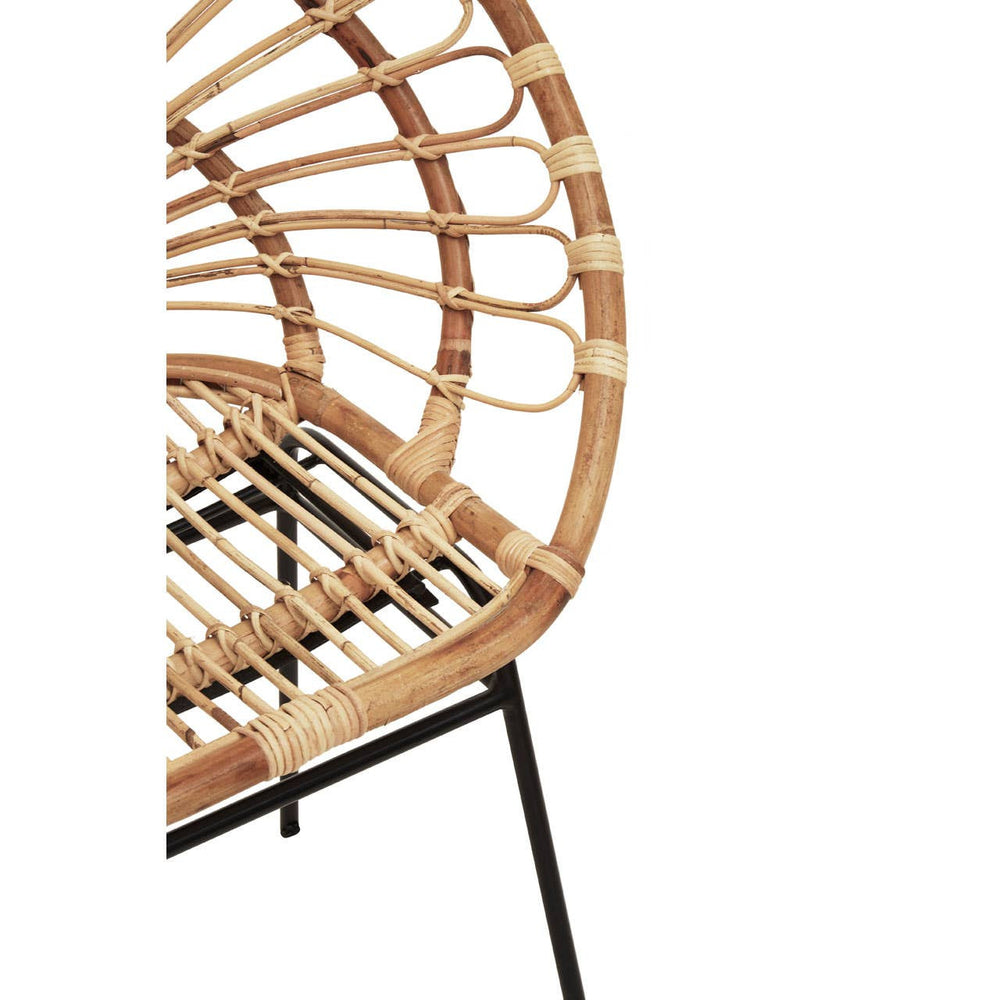 Natural rattan chair with a sunflower-inspired design, featuring a circular backrest and a slatted seat, supported by a sleek black metal frame. The chair showcases a light, earthy tone of the rattan material, highlighting its organic texture and craftsmanship