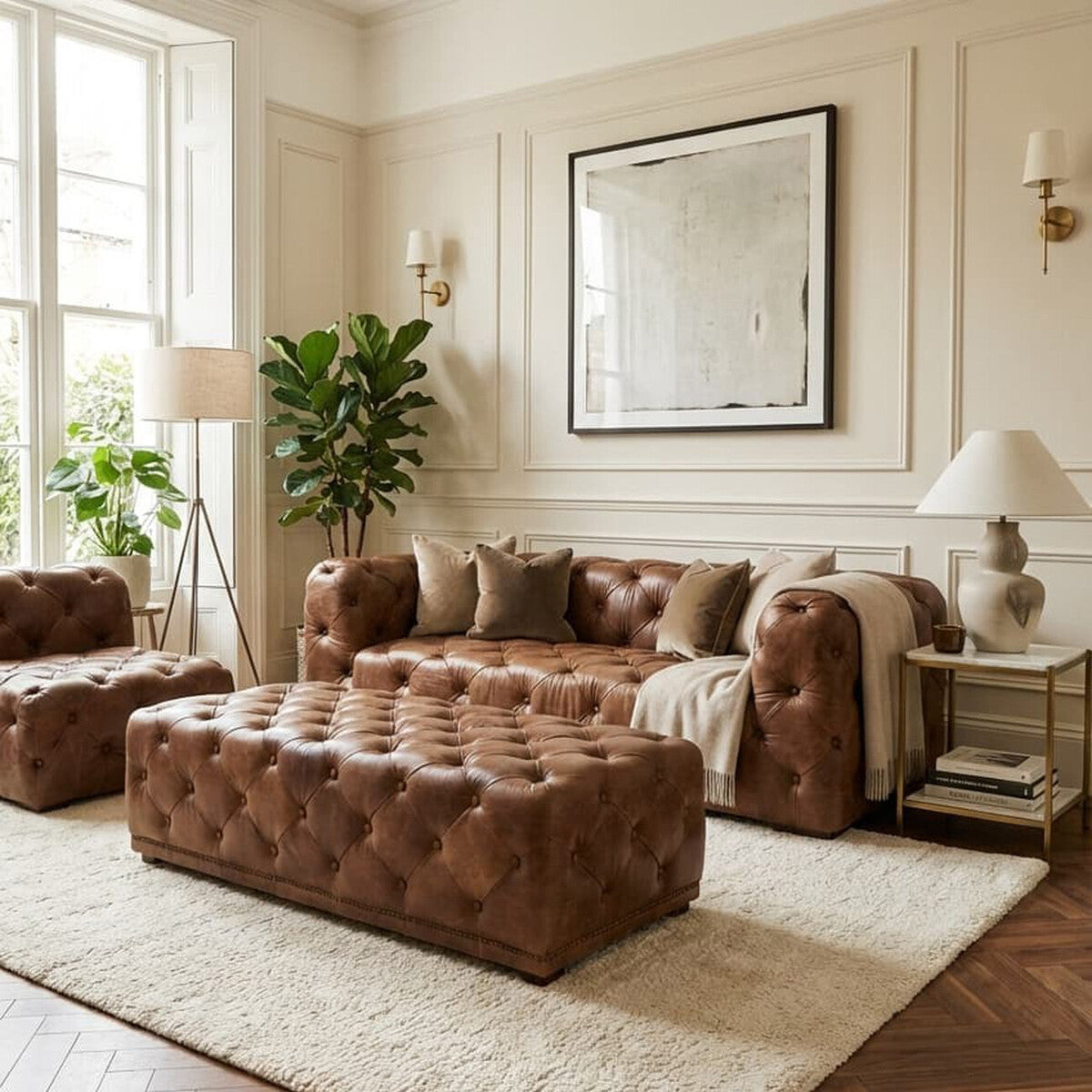 Brown leather rectangle Chesterfield ottoman placed in a stylish living room setting, featuring a tufted design. The room includes a light-colored rug, a large mirror on the wall, a potted plant, and a lamp, creating a cozy and elegant atmosphere