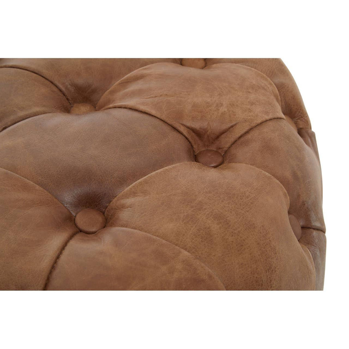 Close-up of brown leather ottoman with deep button tufted upholstery