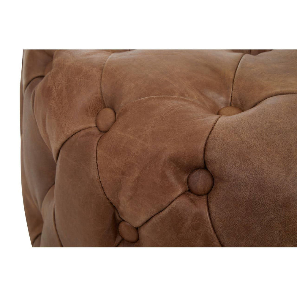 Close up of brown leather Chesterfield sofa with deep button tufting