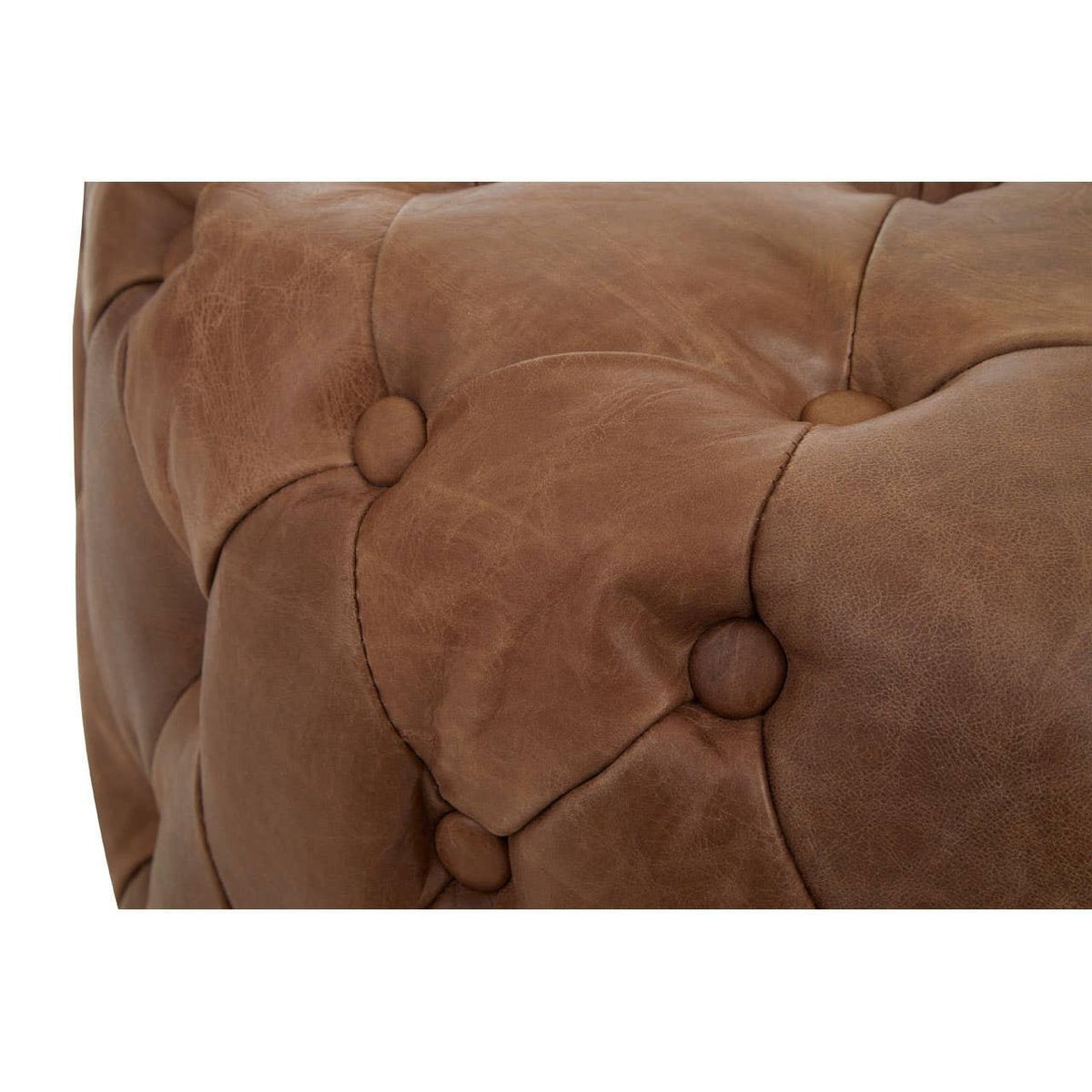 Close up of brown leather Chesterfield sofa with deep button tufting