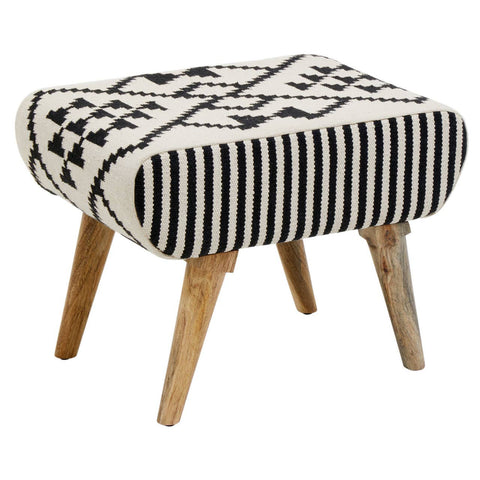A stylish footstool featuring a textured fabric with a black and white geometric pattern, supported by four natural wood legs. The design combines a rounded top with a unique Berber style, adding a modern touch to home decor