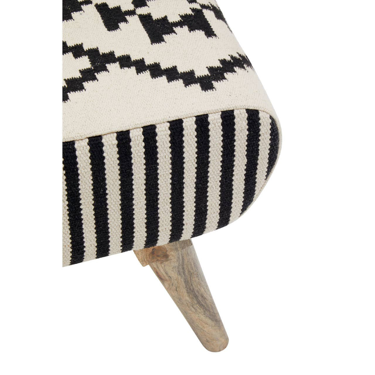 A close-up view of a footstool featuring a textured fabric with a black and white geometric pattern. The footstool has a cushioned top and wooden legs that are slightly angled, providing a modern and stylish look suitable for home decor