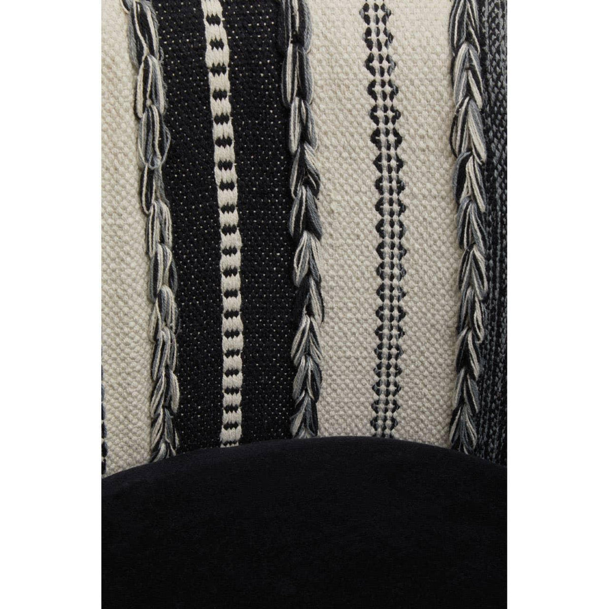 Close-up of textured woven fabric cushion in black and cream with geometric patterns