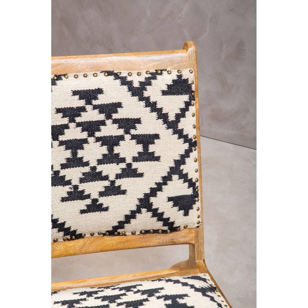 Wooden dining chair with black and cream geometric fabric upholstery and stud detailing