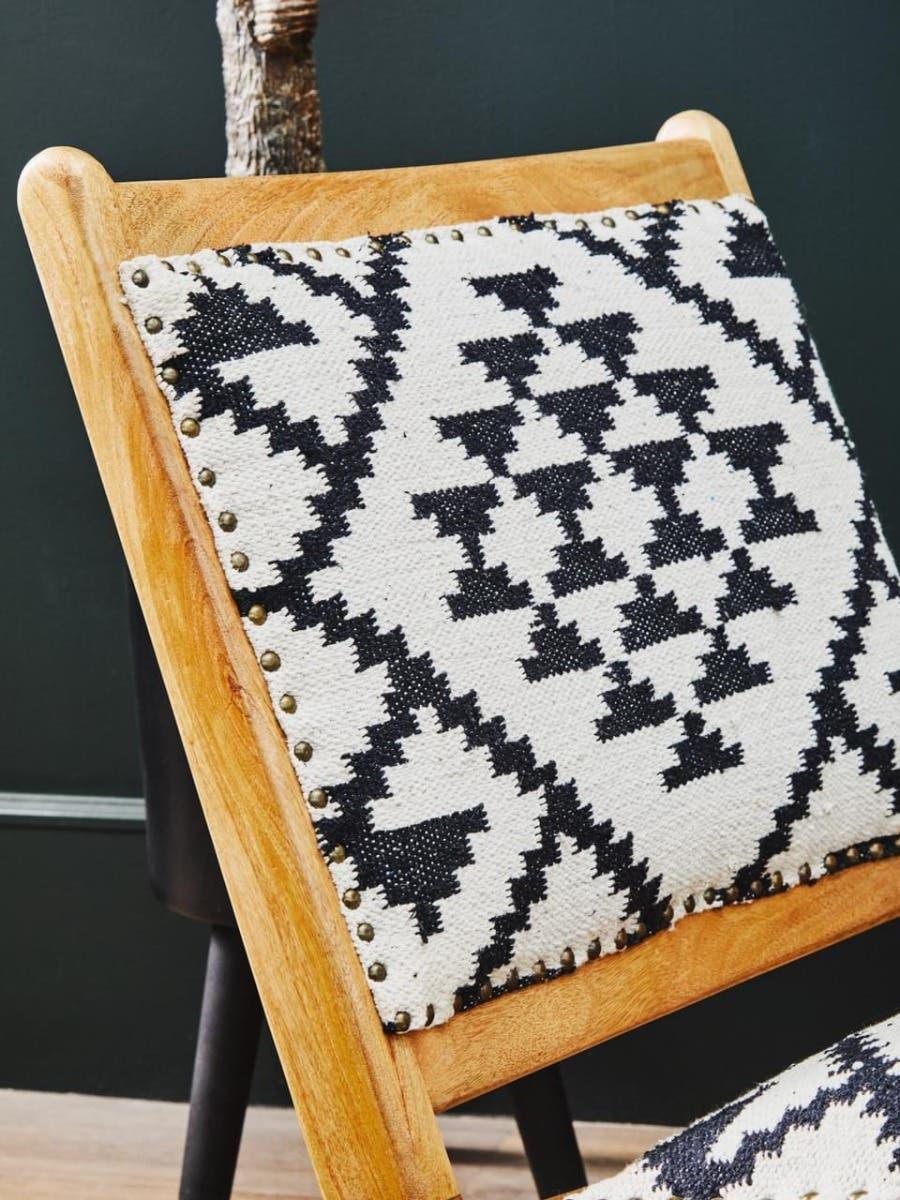 Wooden chair with black and white geometric fabric backrest and stud detailing