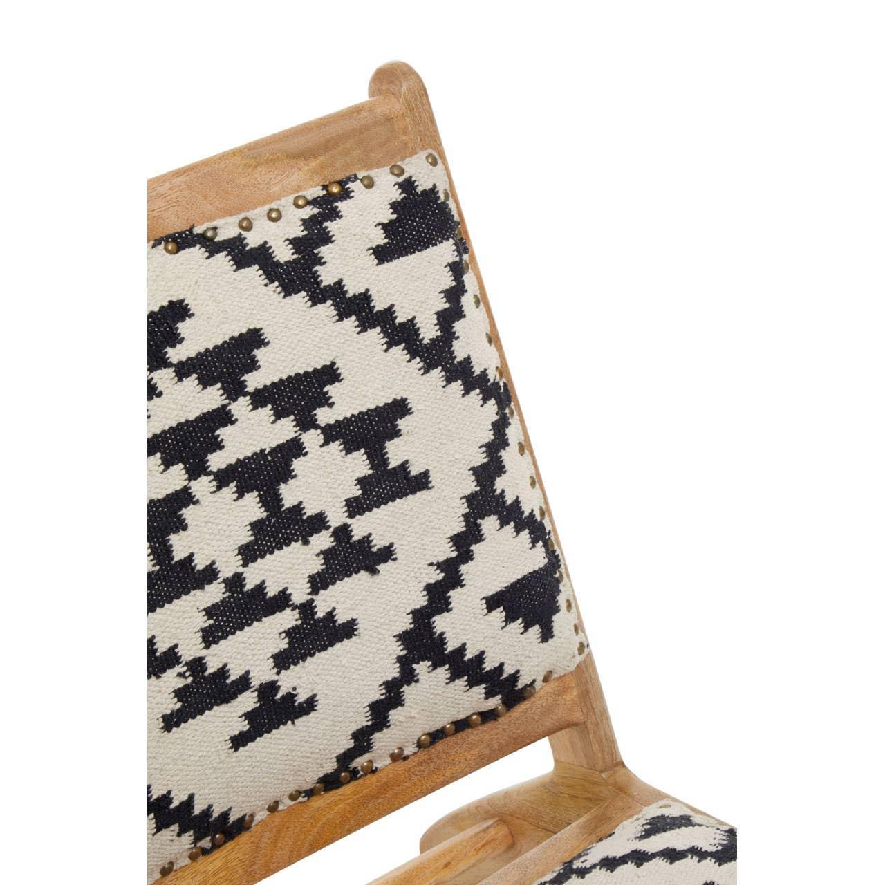 Wooden chair with geometric black and white fabric upholstery and nailhead trim detail